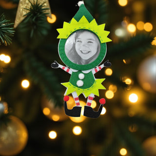 Elf-shaped photo ornament with a blurred Christmas tree background