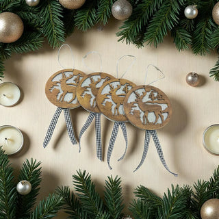 Wooden reindeer ornaments with checkered ribbons on a beige background with Christmas decorations.