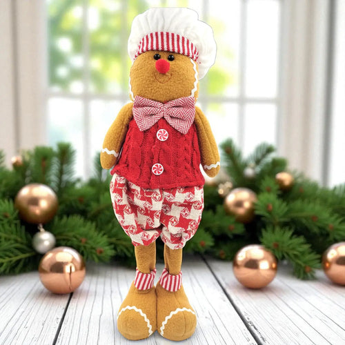 Gingerbread man plush toy in a festive setting with Christmas decorations.