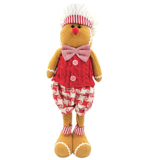 Gingerbread man plush toy wearing a red outfit with a white hat on a white background