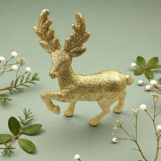 Gold deer ornament with greenery on a light green background, Nordic Aesthetic