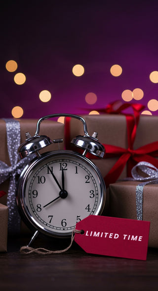 Alarm clock with a 'Limited Time' tag on Christmas presents against a blurred light background