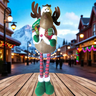 Plush reindeer toy with colorful legs on a wooden surface, city street background