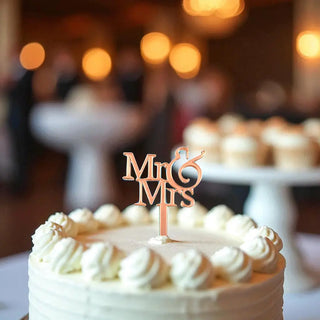 Elegant Mr and Mrs cake topper in wood finish with heart design on a white cake