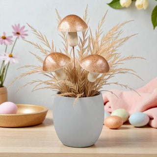 Decorative potted plant with mushrooms on a table with Easter eggs and flowers.