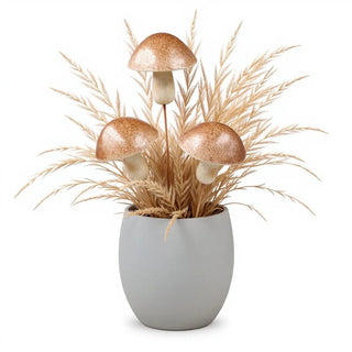 Decorative arrangement with mushrooms and dried grasses in a gray pot on a white background