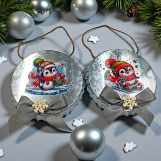 Two Christmas ornaments with penguins and ribbons on a white background