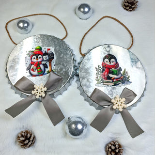 Two decorative Christmas ornaments with penguin designs on a white background.
