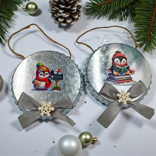 Two Christmas ornaments with penguins and ribbons on a white background