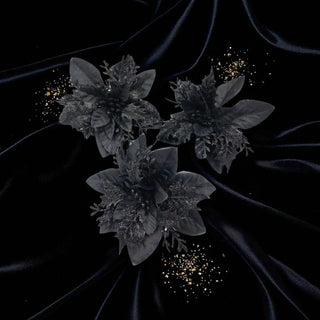 Dark floral arrangement on a black background with gold accents