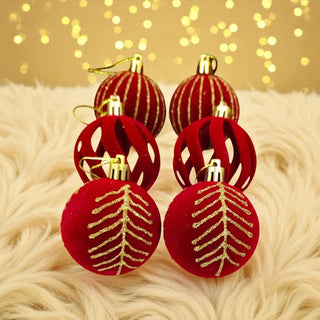 Red and gold Christmas ornaments on a fluffy surface with a blurred light background