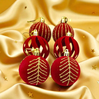 Red Christmas ornaments with gold patterns on a gold fabric background
