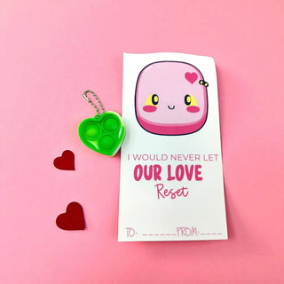 Pink keychain with a heart design on a pink background