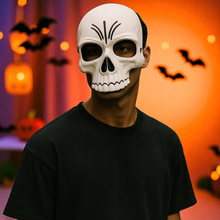Person wearing a skull mask with Halloween decorations in the background