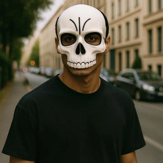 Person wearing a white skull mask on a city street