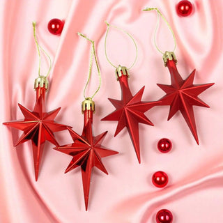 Red star-shaped Christmas ornaments on a pink fabric background