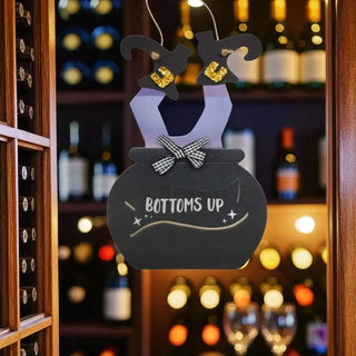 Decorative sign with 'Bottoms Up' text in a restaurant setting