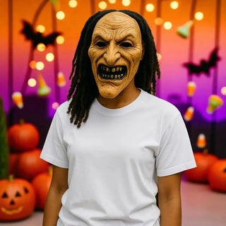 Person wearing a Halloween mask with a colorful background featuring pumpkins and bats.